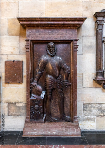 Knights tombstone made of red marble in St Vitus Cathedral facade in historical part of Prague in Czech Republic