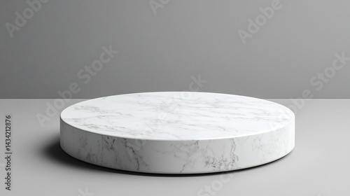 Round marble display platform on grey background; product presentation