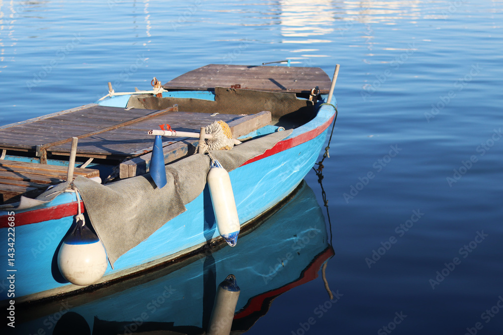 Boats moored to the pier. Details. Small boats on the water, close-up. Summer sunny day on the pier. Old boats. Vacation at sea