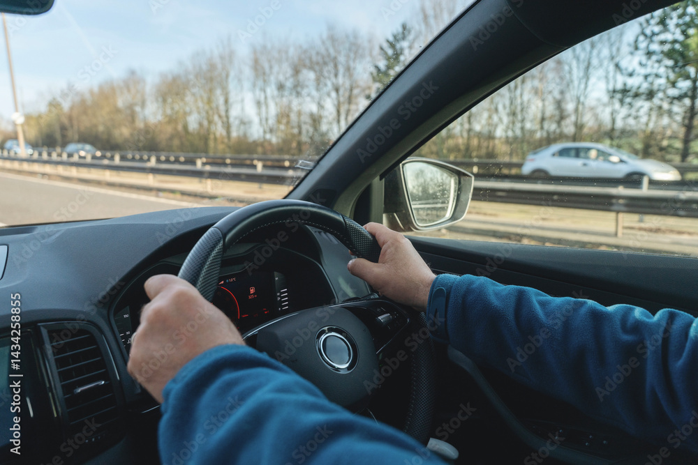 Man driving car with hands on stearing wheel Man driving car with hands on stearing wheel