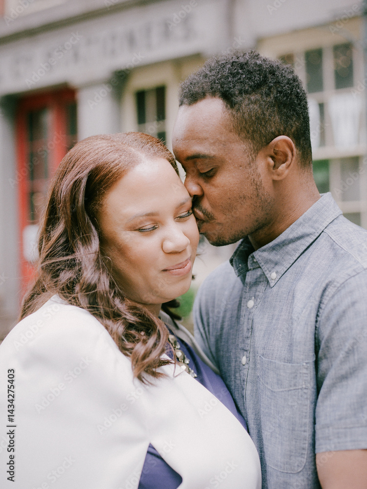 Couple enjoying an intimate moment in a charming urban setting during a sunny afternoon Couple enjoying an intimate moment in a charming urban setting during a sunny afternoon