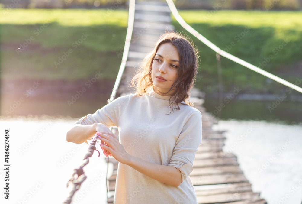 Portrait of a beautiful young brunette woman in the park. Asian girl in a white sweater