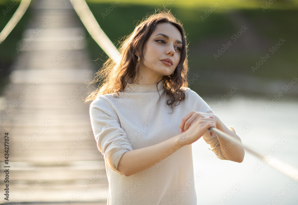 Portrait of a beautiful young brunette woman in the park. Asian girl in a white sweater