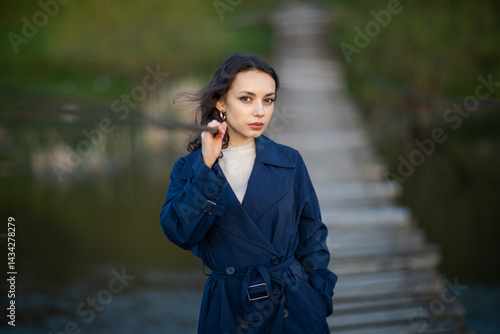 Obraz na płótnie Portrait of a beautiful Asian woman with long black hair and wearing blue coat. w salonie