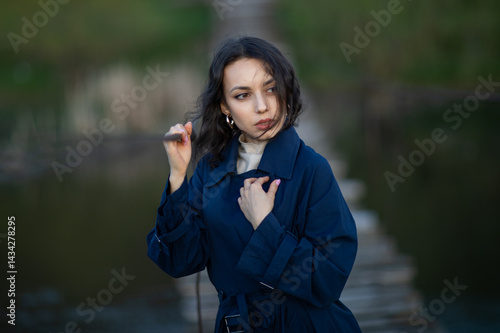 Obraz na płótnie Portrait of a beautiful Asian woman with long black hair and wearing blue coat. w salonie