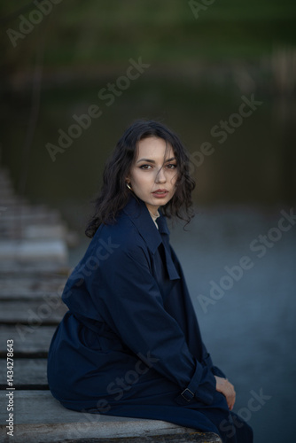 Obraz na płótnie Beautiful brunette meditates sadly in the park in the evening light. Sad girl w salonie