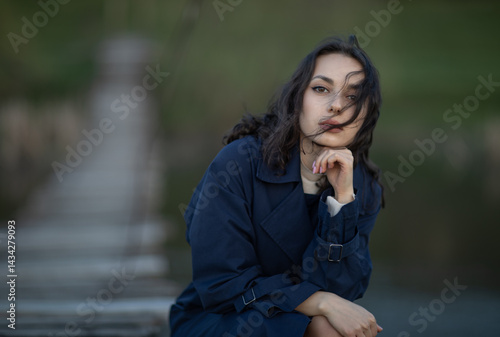 Obraz na płótnie Beautiful brunette meditates sadly in the park in the evening light. Sad girl w salonie
