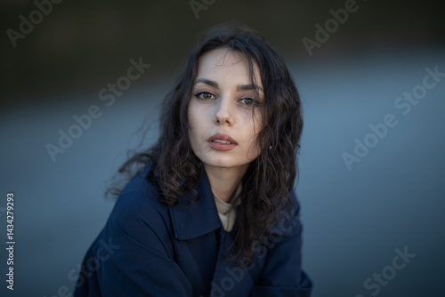 Obraz na płótnie Beautiful brunette meditates sadly in the park in the evening light. Sad girl w salonie