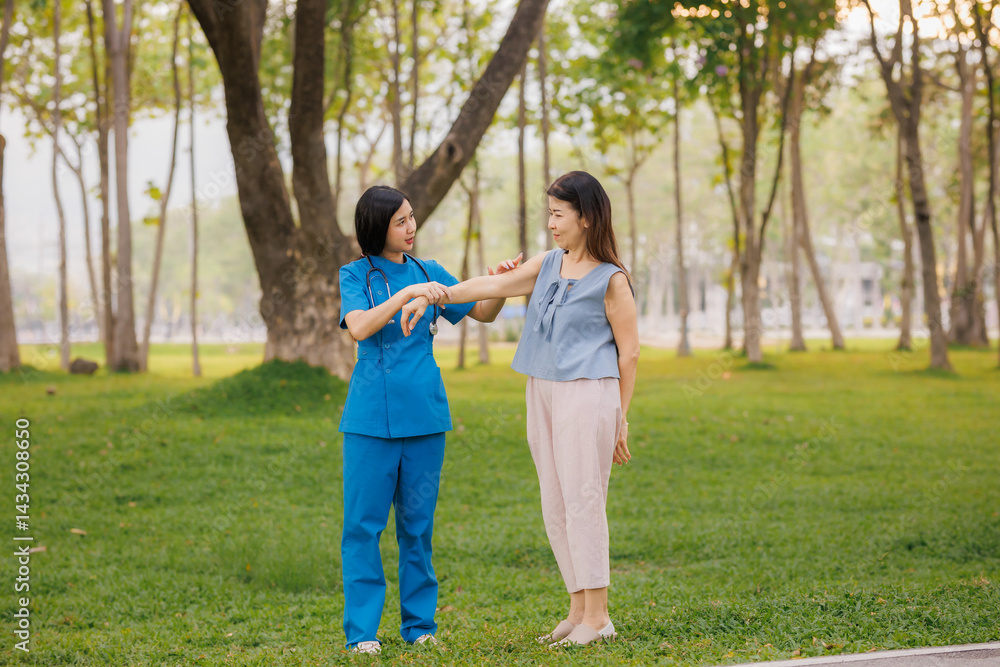 In the heart of a lush park, a caring young Asian female doctor guides her elderly patient through gentle exercises, embracing the refreshing, clean air together. In the heart of a lush park, a caring young Asian female doctor guides her elderly patient through gentle exercises, embracing the refreshing, clean air together.