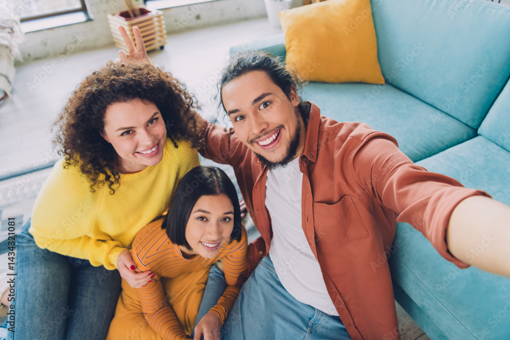 Group of friends enjoying cheerful moments together indoors, illustrating casual lifestyle and diversity in a vibrant home