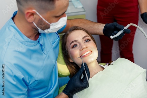 dental procedure, dentist chair, Dental treatment, smiling patient, female patient, Dentist examining, treating teeth,