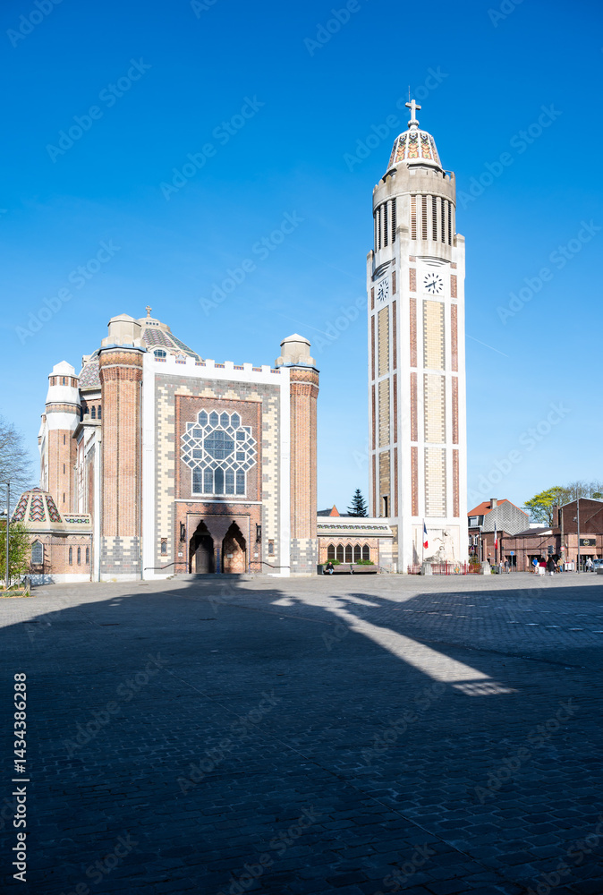 Fototapeta premium Saint Chrysolius and Saint Peter Church with the belfry tower at the old market square of Comines - Hauts De France