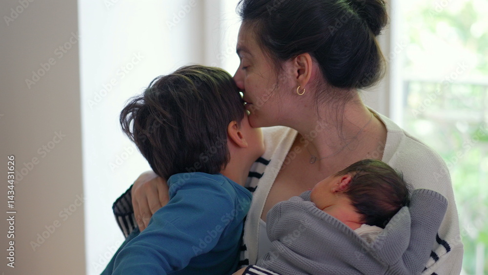Fototapeta premium Older boy kissing both mother and newborn baby, creating a tender and heartwarming family moment filled with love and connection, highlighting the bond between siblings and mother-SD 480p