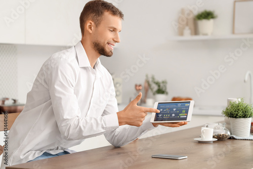 Young man using smart home ...