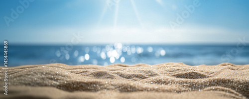 Obraz na płótnie Background with sand in the foreground and sky in the background. summer beach nature with rays of sunlight. golden sand beach. sea water against blue sky with clouds w salonie