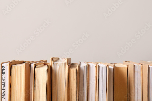 Row of books on grey backgr...