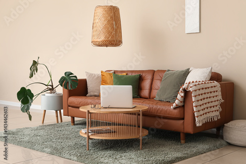 Brown leather sofa and wood...