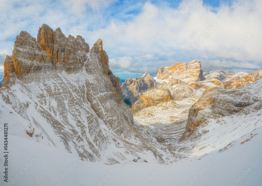 View of the Dolomites, Italy. Mountain landscapes with snow and ice. Sharp rocks as a background. Place for mountain hiking, traveling and vacation. Wallpaper, postcard, photo.