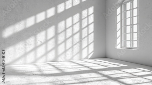 Empty white room with window light casting shadows on the wall and floor.