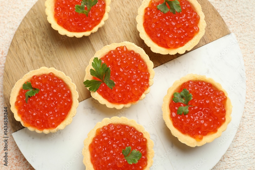 Tartlets with red caviar and parsley on beige background, top view Tartlets with red caviar and parsley on beige background, top view