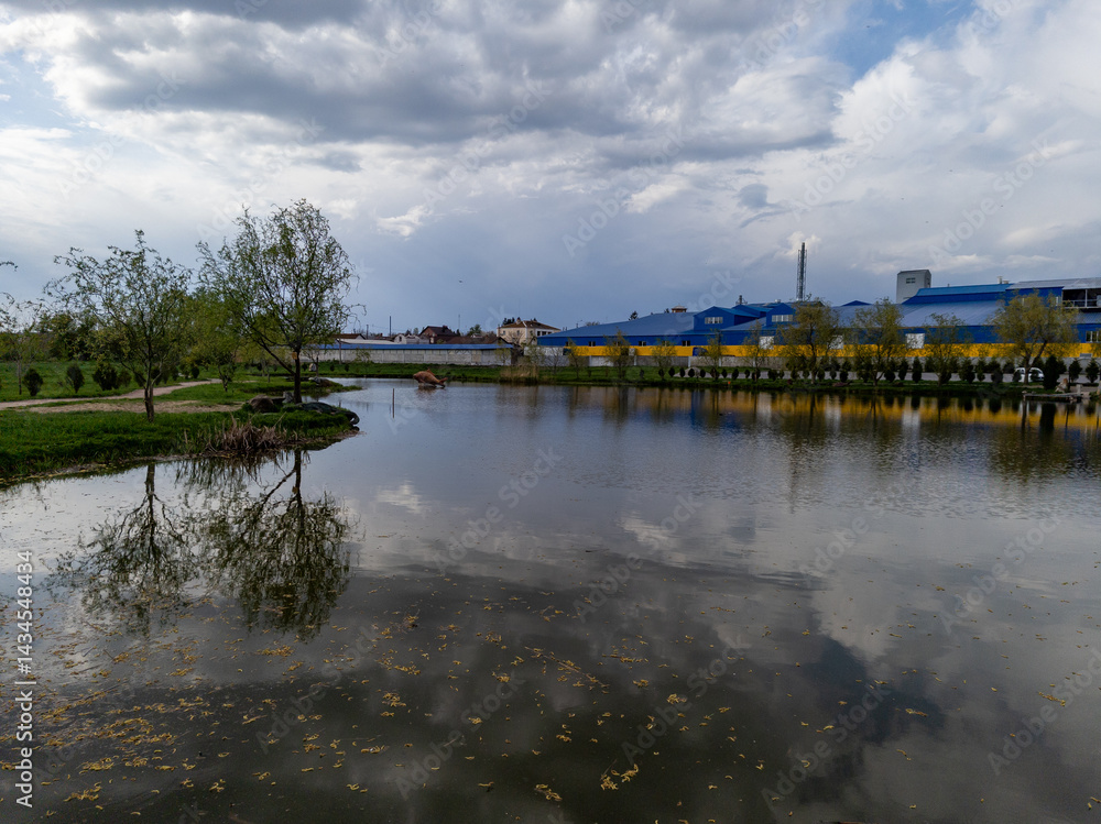 A large body of water surrounded by trees and buildings A large body of water surrounded by trees and buildings
