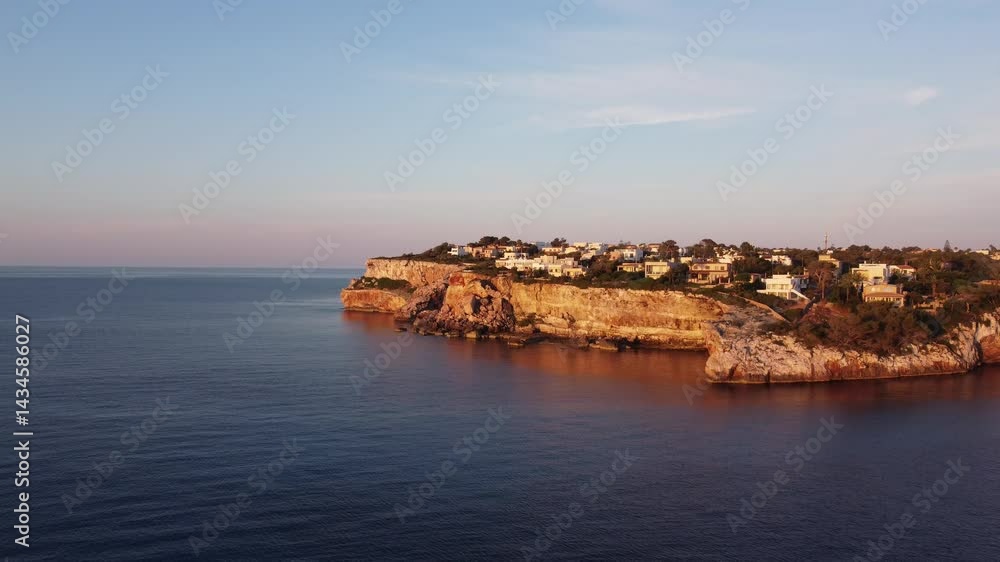Aerial view of a coastal village on the Mediterranean Sea at sunset. Aerial view of a coastal village on the Mediterranean Sea at sunset.