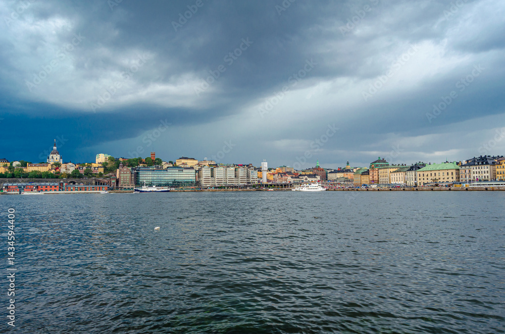 Fototapeta premium Urban scene in Stockholm, Sweden with storm clouds in the background