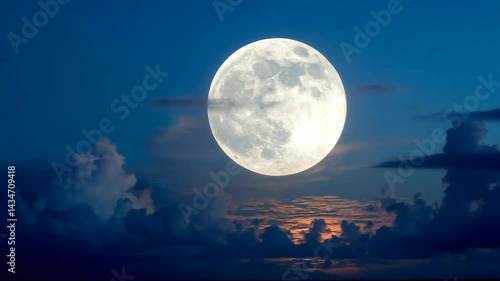 Bright full moon glowing in deep blue night sky with scattered clouds, celestial event with dramatic, atmospheric skyscape