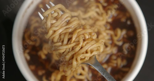 Hot instant noodles soup, Ramen soup on fork. 