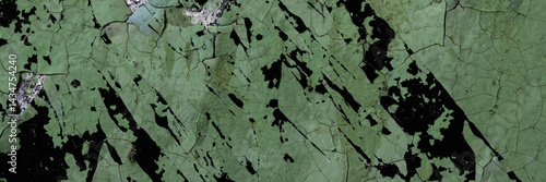 Obraz na płótnie Peeling paint on the wall. Panorama of a concrete wall with old cracked flaking paint. Weathered rough painted surface with patterns of cracks and peeling. Grunge texture for wide panoramic background w salonie