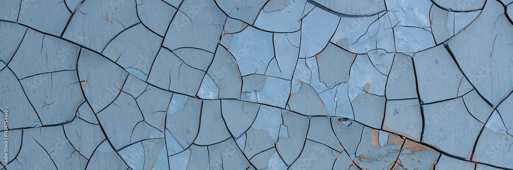 Peeling paint on the wall. Panorama of a concrete wall with old cracked flaking paint. Weathered rough painted surface with patterns of cracks and peeling. Wide panoramic texture for grunge background