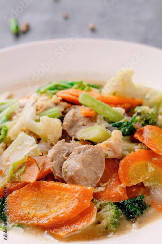 A plate of food with a variety of vegetables and meat