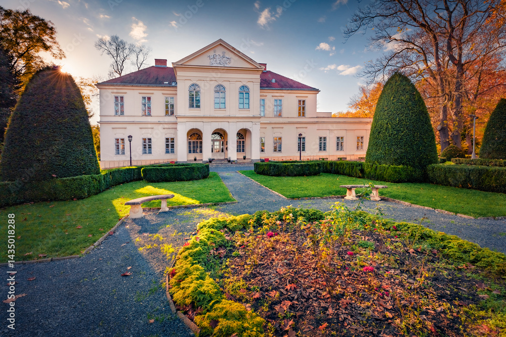 Spectacular autumn view of Ernuszt castle. Wonderful sunset in Hungary, Europe. Gorgeous evening cityscape of Ernuszt town, Europe. Trees covered with orange and crimson leaves.