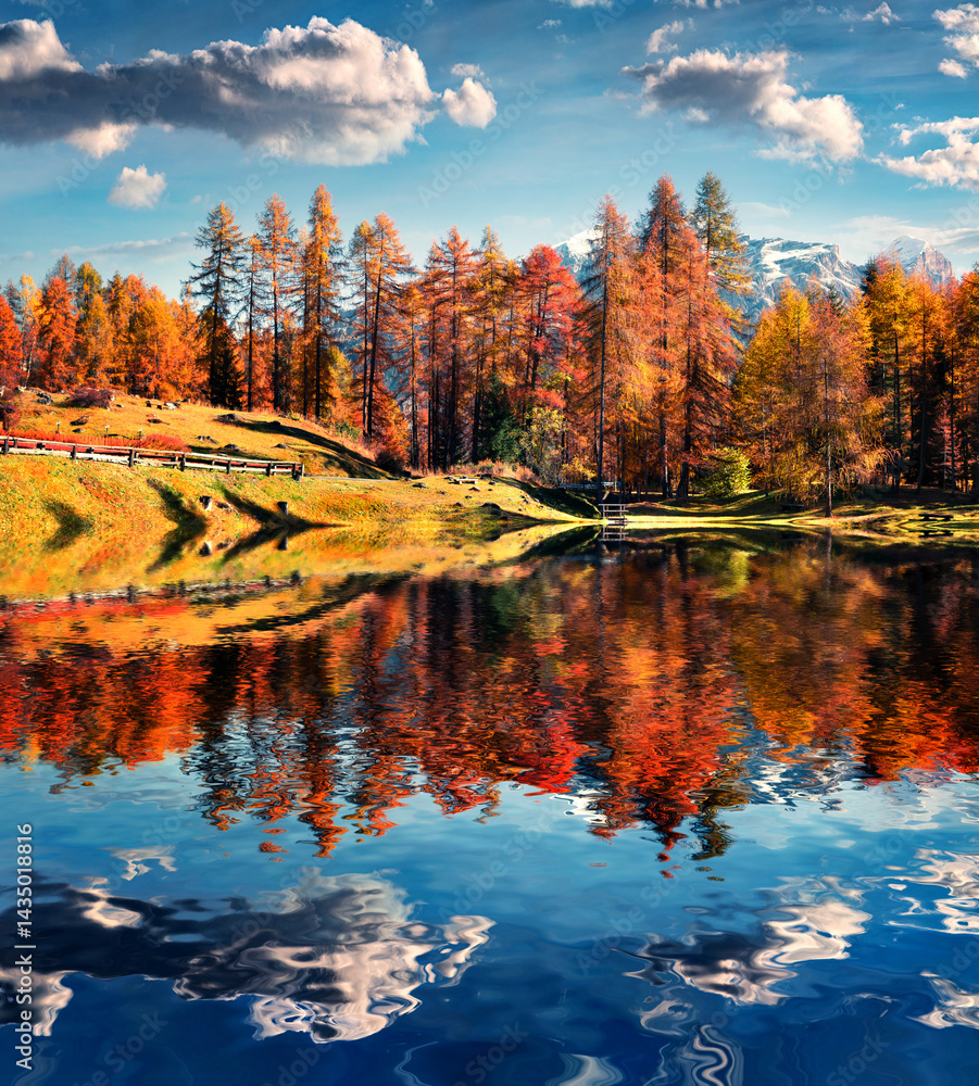 Fantastic colors view of Scin lake with yellow pine trees.