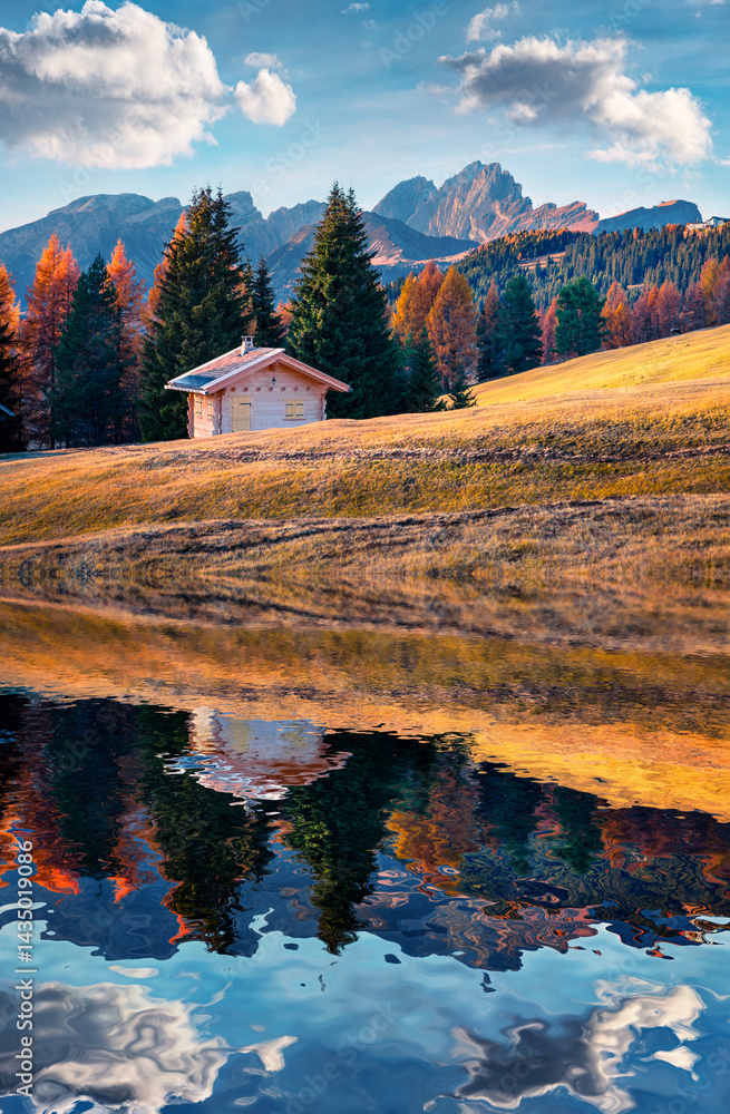Incredible outdoor scene in Alpe di Siusi with beautiful yellow larch trees and Furchetta mountain on background.