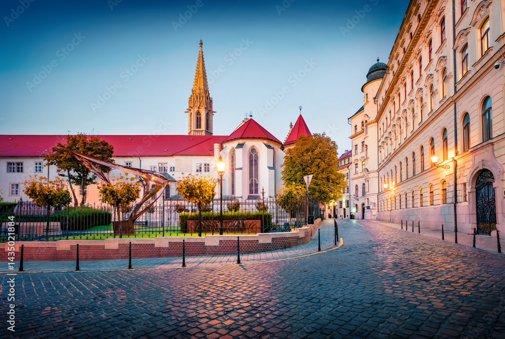 Fantastic autumn view of Franciscan garden with a bell of Franciscan Monastery. Calm morning scene of empty street of Bratislava, capital of Slovakia, Europe. Traveling concept background..