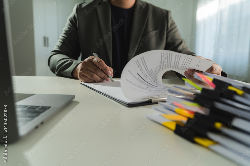 businesswoman signing document On Contract Paper reading and checking financial documents