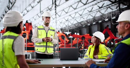 Multiethnic Team Of Engineers Discussing Production