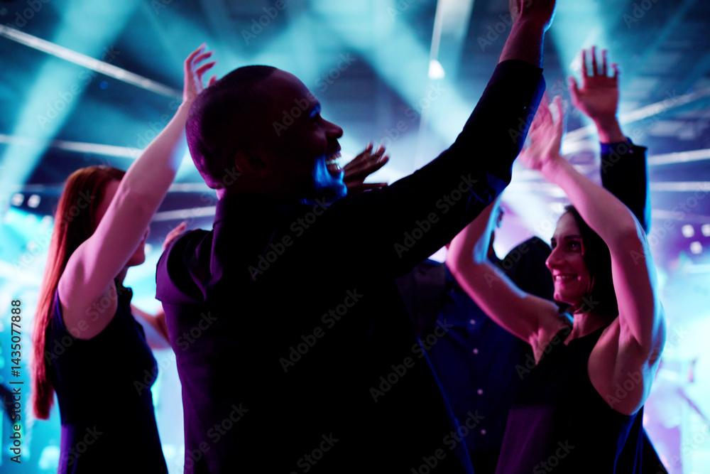 Diverse Group Of People Dancing In Nightclub