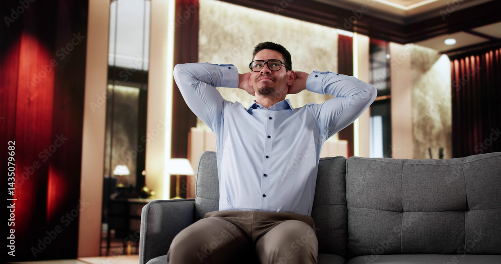 Happy Man Sitting On Sofa Thinking