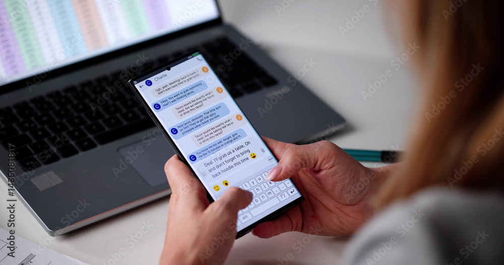 Young Woman Sends Text Message On Mobile Phone At Home