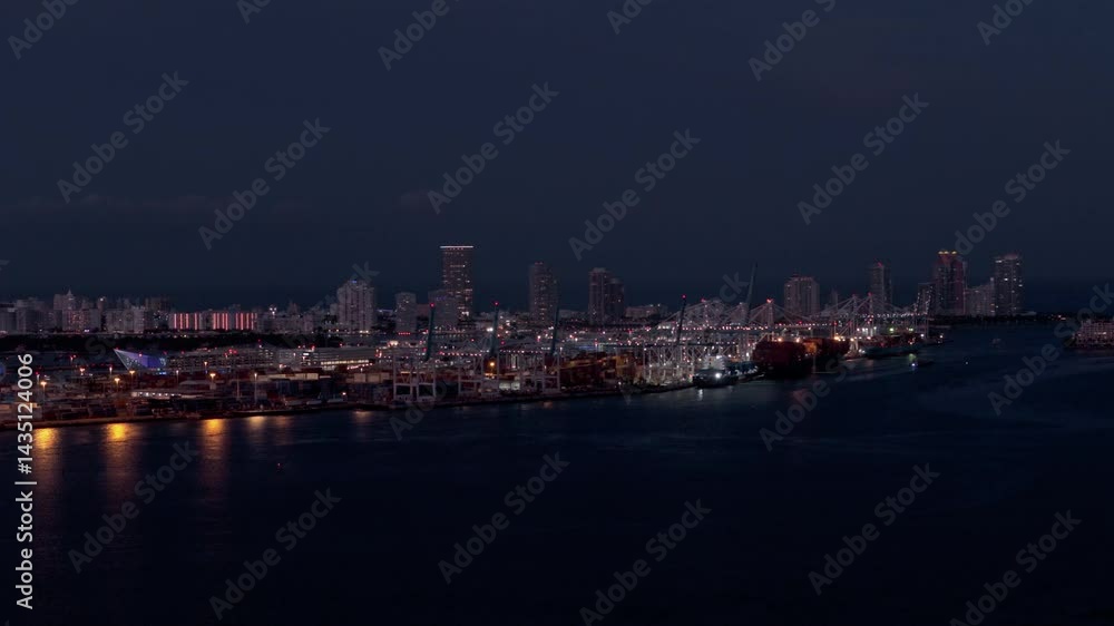 Modern Skyscrapers on coast of Miami in dusk Illuminated by Sunset Light. View from the sea Modern Skyscrapers on coast of Miami in dusk Illuminated by Sunset Light. View from the sea