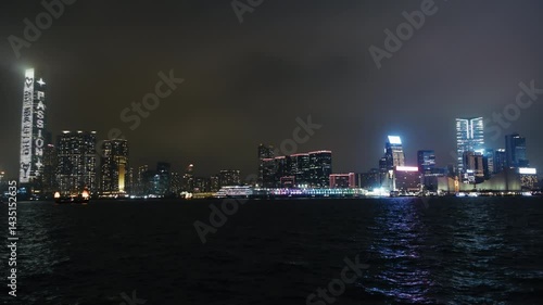 Wallpaper Mural Stunning nighttime skyline of Hong Kong featuring illuminated skyscrapers along the waterfront. The video captures reflections on the water surface and city lights Torontodigital.ca