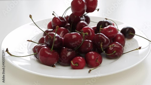 Blurred Shooting with a Person Taking Sweet and Delicious Red Cherry Fruits from the Plate.