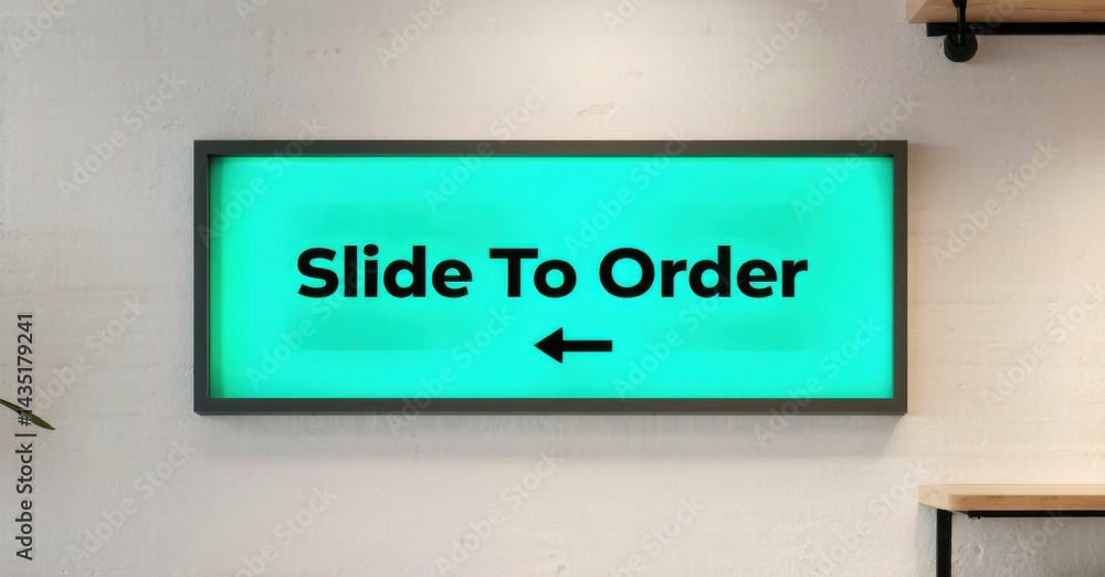 Obraz premium Rectangular screen displays Slide To Order message. Turquoise background, black frame, arrow indicates direction. Simple, modern design.