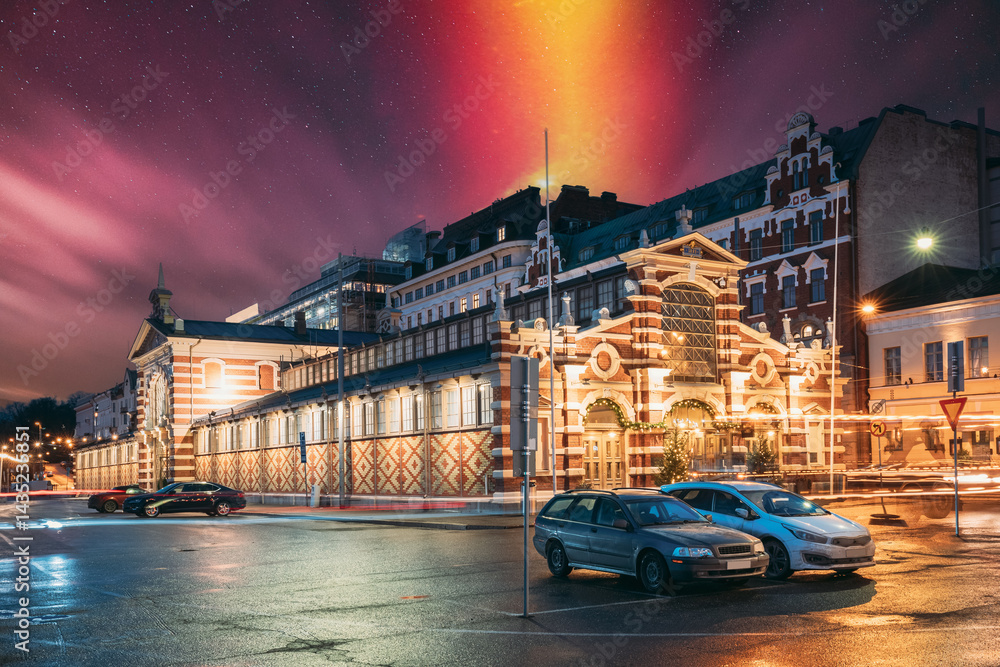Helsinki, Finland. Old Market Hall Vanha Kauppahalli In City Center In Lighting At Evening Or Night Illumination. Famous Popular Place. Night stars shining above street