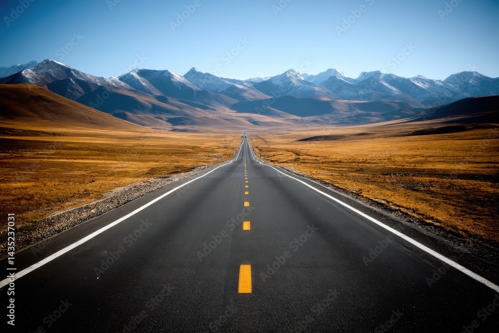 Naklejka premium Serene Road Journey Through Golden Fields Leading to Majestic Snow Capped Mountains Under Clear Blue Sky Capturing the Essence of Travel and Adventure