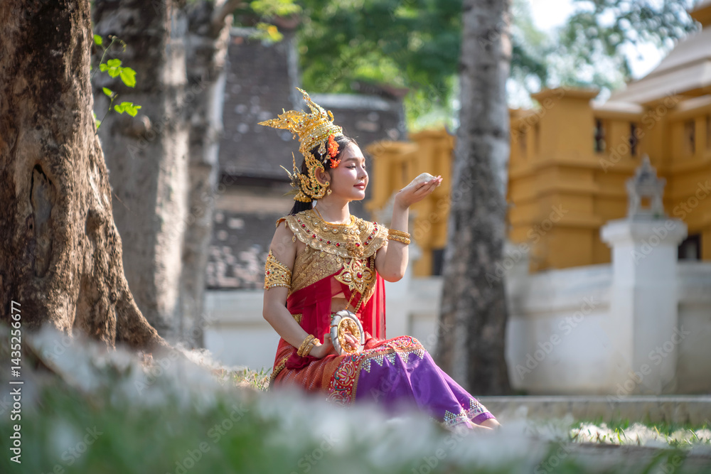 Beautiful young woman wearing Thai Songkran costume, a regional Thai costume dress in Chiang Mai, Thailand.