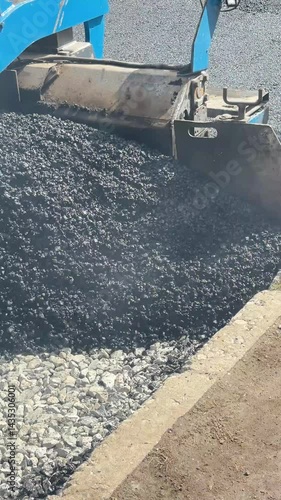 Road construction: asphalt laying process with heavy machinery in action