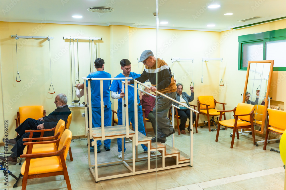 Elderly man doing rehabilitation exercises climbing stairs with physiotherapists assisting